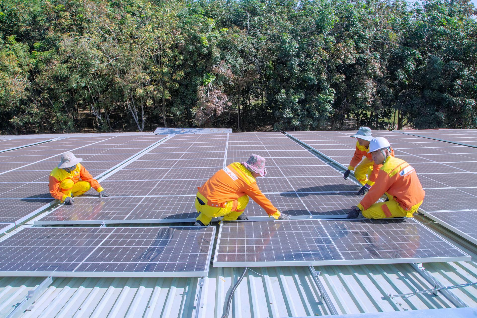Solar engineers at work on a rooftop servicing panels